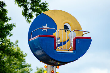 Close-up of an old, dirty amusement park moon ride 