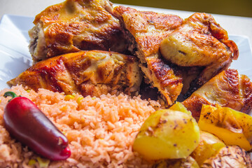This artistic arrangement displays luscious grilled chicken paired with seasoned rice and roasted...