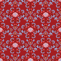 Seamless vector pattern with bright abstract flowers in folk art style on a vivid red background. Colorful decorative design perfect for fabric, wrapping paper, wallpaper, and festive projects.
