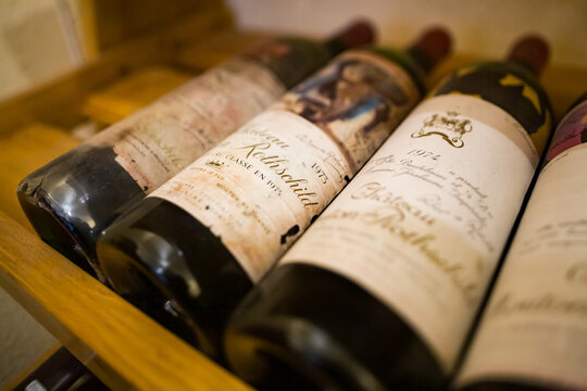 Bergerac, France - November 3, 2007: display shelf of precious bottles of Mouton-Rothschild red wine from 1973, with label designed by Picasso, and 1974 label designed by Robert Motherwell