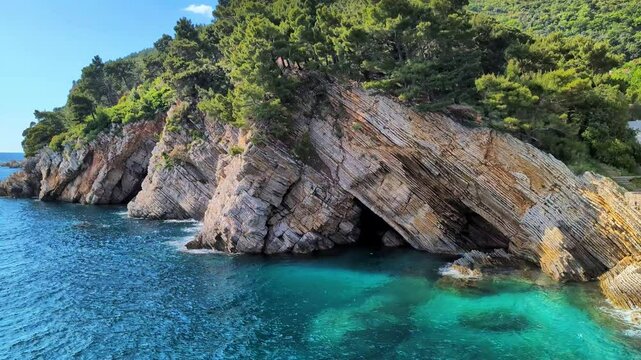 Beautiful blue water lagoon rocky cliffs in Petrovac, Montenegro Europe sunny travel