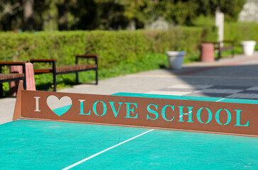 a tennis court with a sign that says i love school