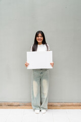 Fototapeta premium young woman holding blank board
