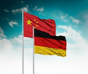 National flags of China and Germany wave side by side in a clear blue sky symbolizing...