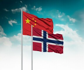  National flags of China and Norway wave side by side in a clear blue sky symbolizing international...
