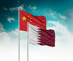  National flags of China and Qatar wave side by side in a clear blue sky symbolizing international...