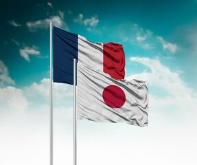  National flags of France and Japan wave side by side in a clear blue sky symbolizing international unity and cooperation.