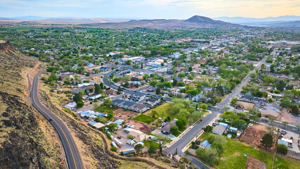 Aerial Small Town Suburbs and Winding Road in Southwest Landscape Fly Over