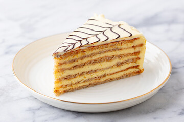 Esterhazy cake on a white plate. Marble background. Close up.