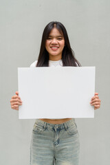 young woman holding a blank sign