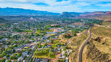 Aerial Suburban Neighborhoods and Desert Mountains in Hurricane Utah Fly Over