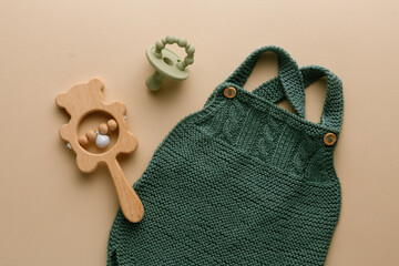 knitted baby romper and accessories on neutral fabric background flatlay newborn outfit