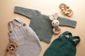 knitted baby romper and accessories on neutral fabric background flatlay newborn outfit
