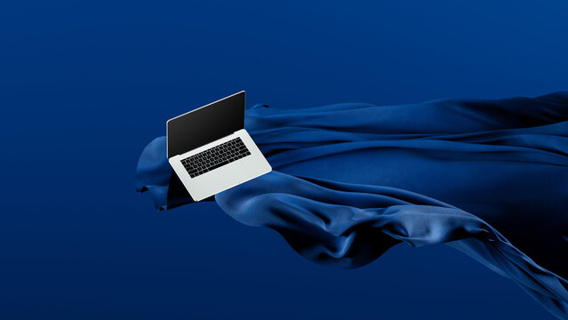 Light laptop on flowing fabric against a blue backdrop