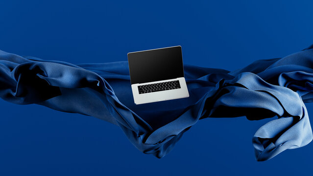 Light laptop on flowing fabric against a blue backdrop