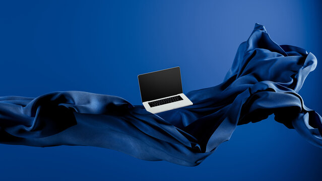 Light laptop on flowing fabric against a blue backdrop