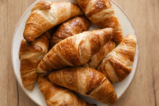Freshly baked homemade croissants on a rustic plate - Powered by Adobe