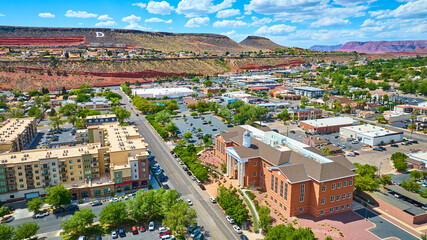 Aerial Downtown St George Courthouse and Apartments with Red Rock Cliffs Fly Over