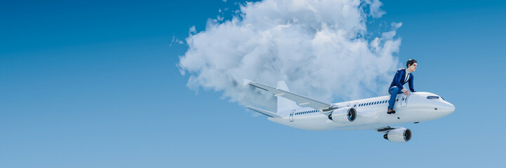 Business Travel concept. A businessman in a suit is riding an airplane in front of a blue sky with one cloud. Web banner format with copy space