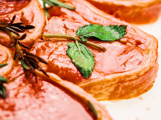 Premium quality marinated lamb loin chops and rosemary herb on white background. Uncooked raw meat...
