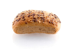 One small premium roll with seeds and grain on white background with reflection. Fine bakery product made from high quality premium ingredients, Small taste crusty bread.