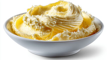 Creamy whipped butter in white ceramic bowl on white background close-up shot.