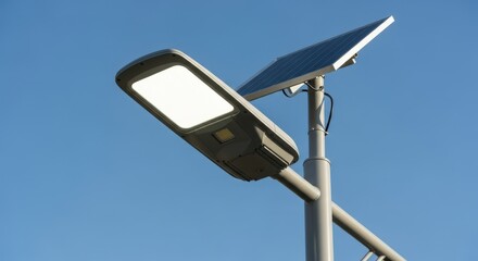Solar powered street light on a pole. Modern energy saving technology for public illumination. Sustainable urban infrastructure with clear sky.