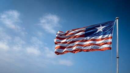 Liberian flag waving proudly on independence day in a clear blue sky