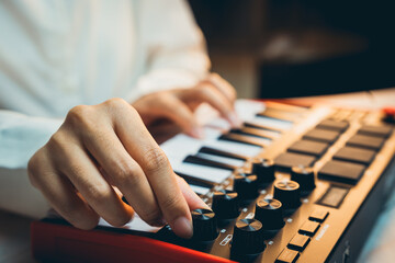 Pianist Concept. Close-Up View of a Music Producer Playing MIDI Keyboard with Creative Focus and Artistic Passion in a Studio Environment