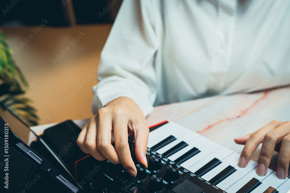 Poster pianist concept. close-up of person adjusting synthesizer controls while creating music in a modern 