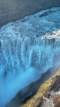 Witness the powerful Dettifoss waterfall in Iceland as water thunders over rocky cliffs. This natural wonder showcases dramatic scenery, vibrant hues, and an awe-inspiring atmosphere at dusk.