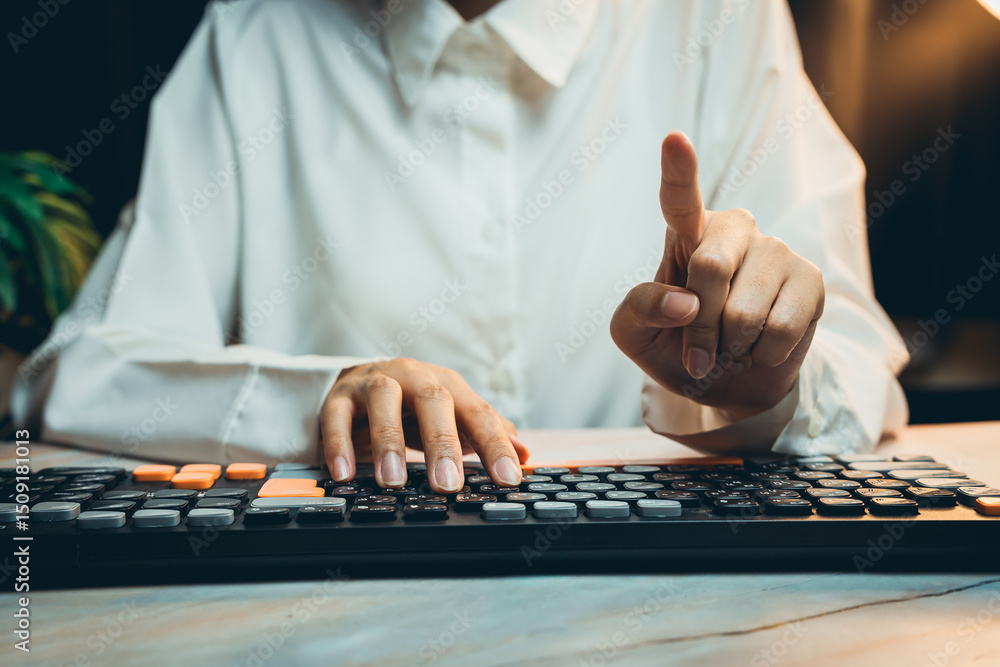 Poster business concept of working. person pointing while typing on keyboard with a focused expression in a
