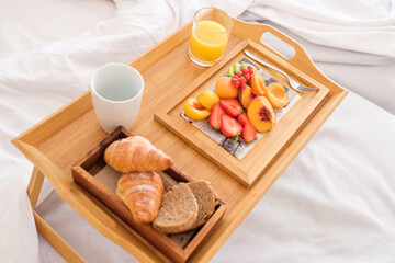 Tray with breakfast on bed