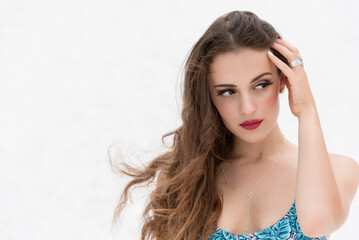 Confident woman in tropical bikini top against bright white background