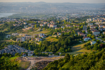 Expansive Aerial View of Residential Neighborhoods and Urban Development with Lush Greenery in Başiskele, Kocaeli, Türkiye at Sunset