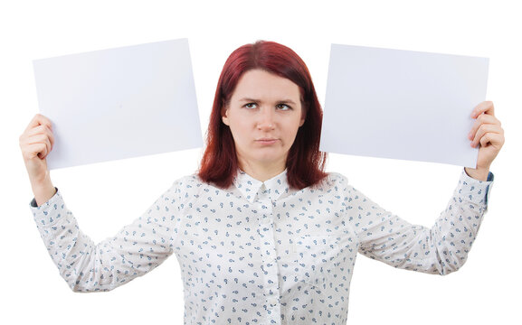 Confused young woman holding two blank paper sheets in her hands poinded to the left and right sides. Human emotion, face expression life perception concept. Business decision and choice symbol