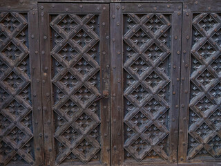 Wooden entrance door, in an ancient church, with a special pattern