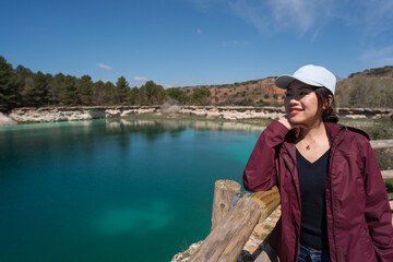 Fototapeta premium Young Asian woman enjoying the view at Lagunas de Ruidera, Spain