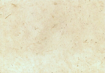 Handmade paper with a textured surface featuring visible natural fibers. The fibers are randomly dispersed, giving it a rustic, organic appearance. Soft beige or cream paper background