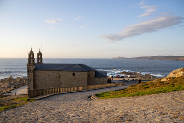 Sanctuary of A Virxe da Barca in Muxía, Galicia, Spain, perched on dramatic Atlantic cliffs. A key...