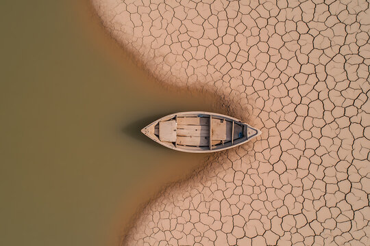 Boat stranded amidst drought, a stark climate change reminder.