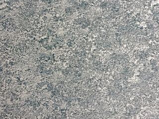 Texture of a rough surface with a mix of blue and gray tones captured in natural light during daytime