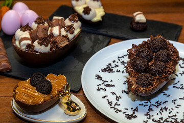 Chocolate easter eggs on top of black stone with wooden background