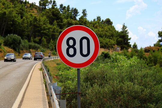 Road sign 80, speed limit 80 on mountain road in Croatia, selective focus. Speed limit sign on traffic background