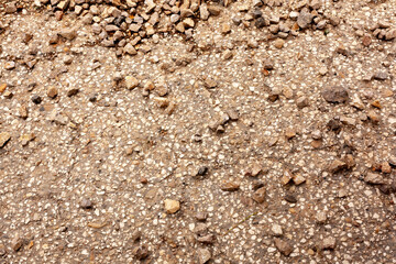 Closeup of gravel on rough concrete surface
