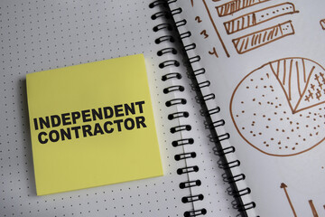 Concept of Independent contractor write on book and chart isolated on Wooden Table.