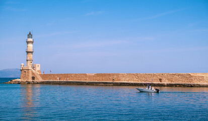 Chania Crete. Lighthouse at old venetian harbour, blue sky
