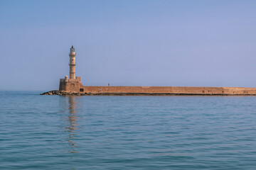 Chania Crete. Lighthouse at old venetian harbour, blue sky