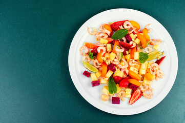 Salad with tropical fruits and shrimps.