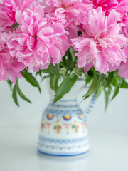  Bouquet of pink peonies in vase close up